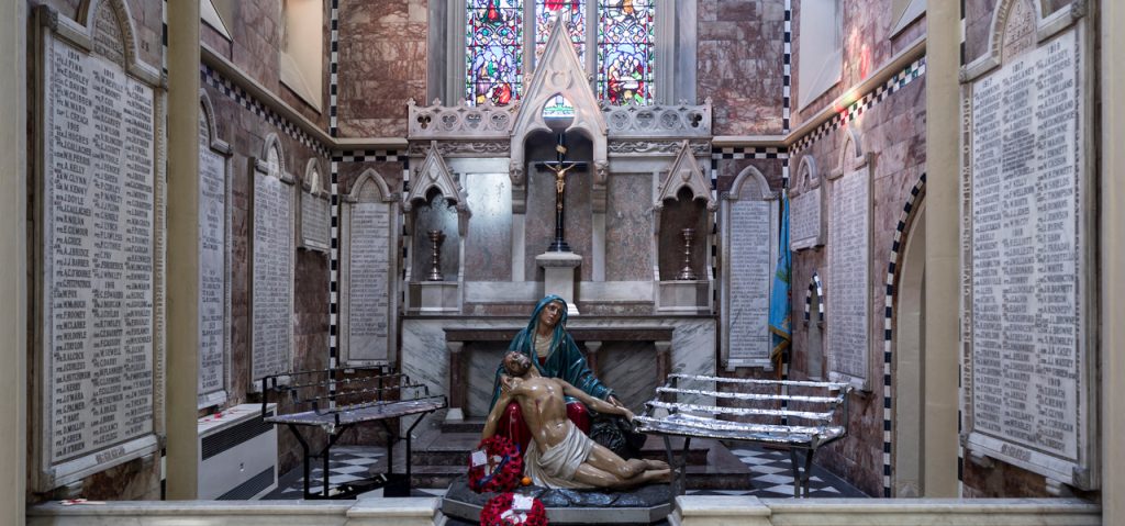 Image of the WW1 memorial chapel with alter, statue of Our Lady holding her son after he has been taken down from the cross with the names of all soldiers from the Diocese adorning the walls of the chapel.
