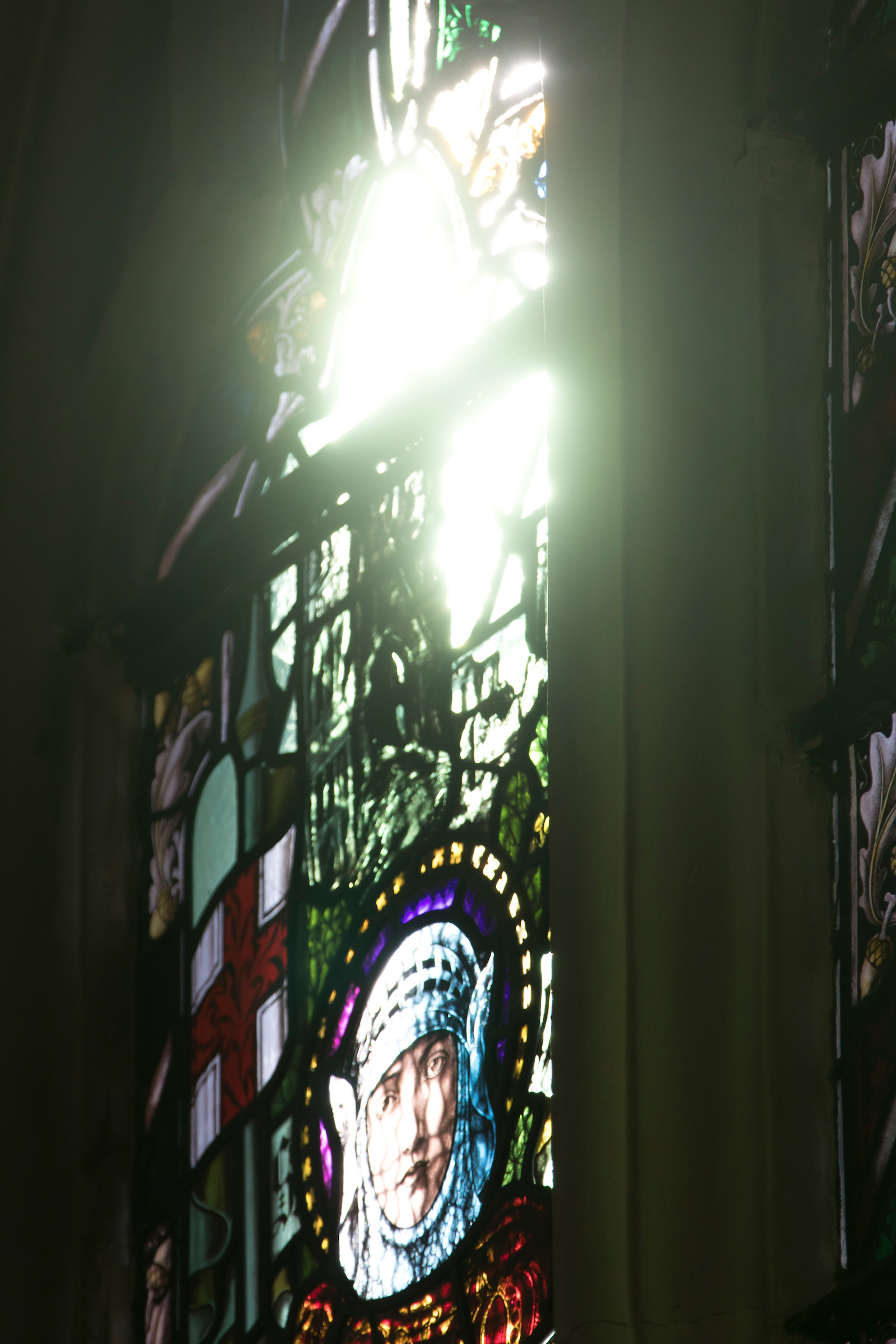 A photo of Our Stained Glass window of St.George shining light on the Cathedral